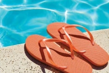 Flip flops sitting near Woodland Acres Townhomes's swimming pool in Liverpool, New York