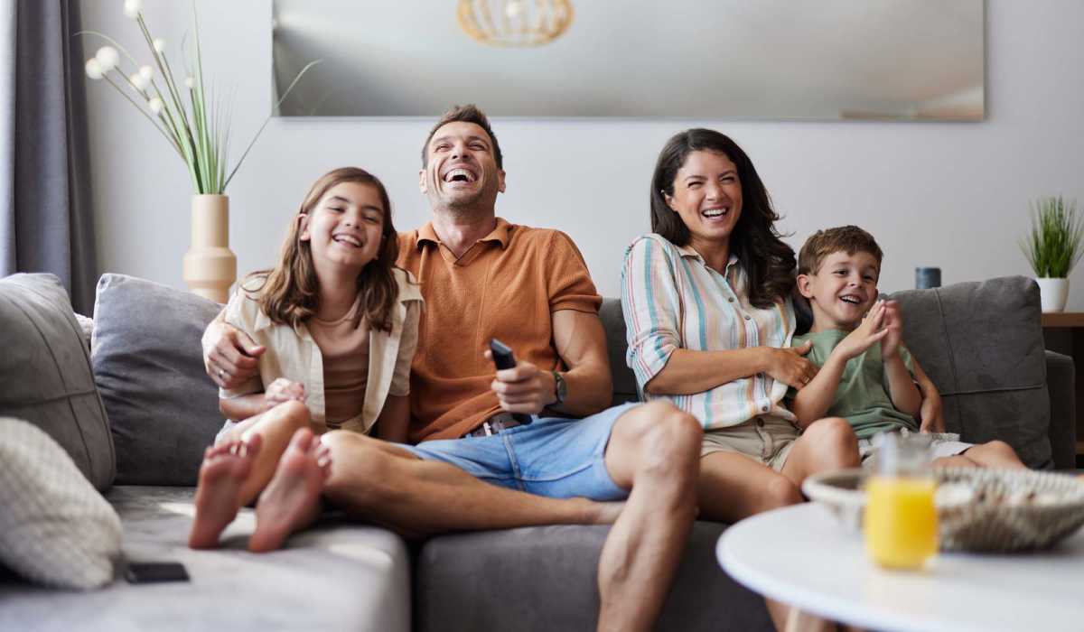 Happy resident family in the iving room at Ridge Commons in Lafayette, Louisiana