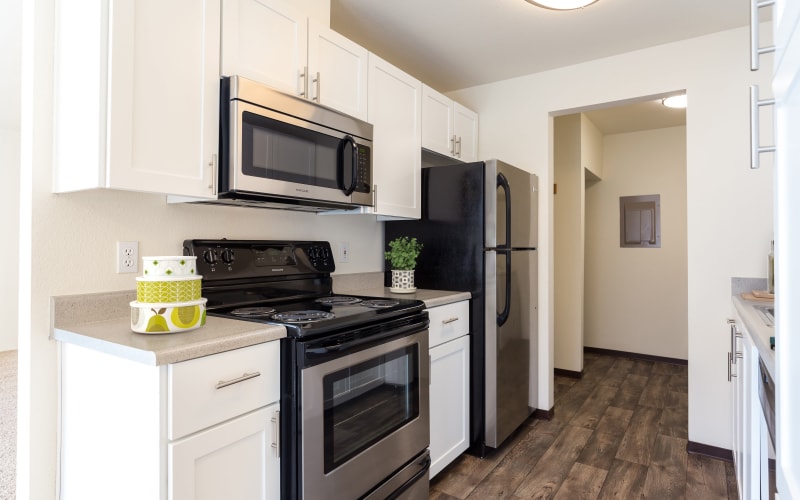 Renovated kitchen with white cabinets at Renaissance at 29th Apartments in Vancouver, Washington