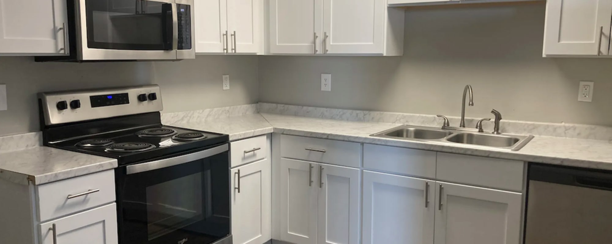 Modern kitchen with stainless-steel appliances at Alston Arms Apartments in North Charleston, South Carolina