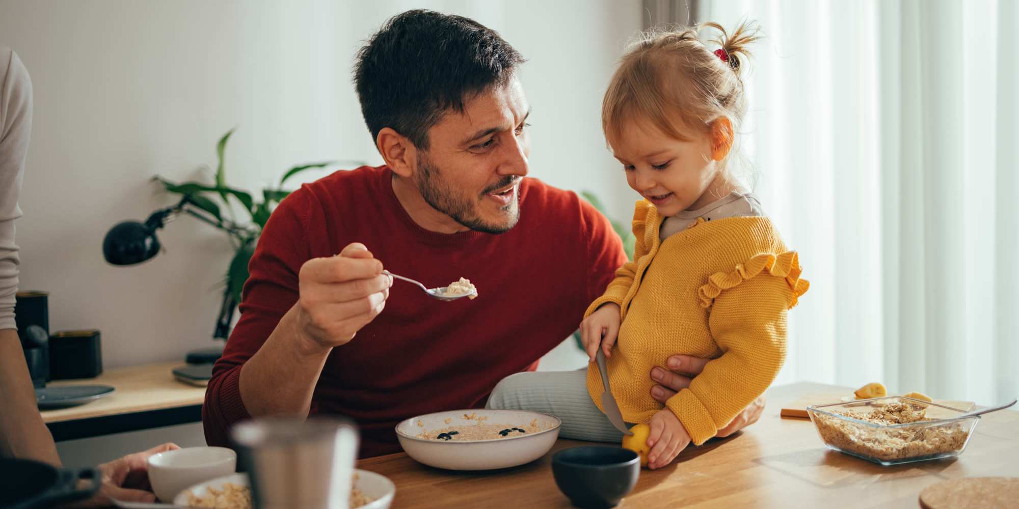 Father and daughter at a cozy dining nook in an inviting home at Loop Commons in Lafayette, Louisiana
