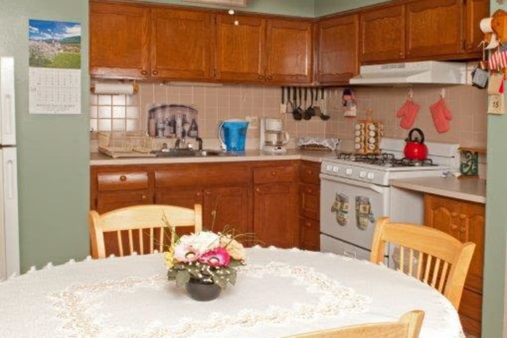 Kitchen with wooden cabinets at Lynn York Apartments in Irvington, New Jersey