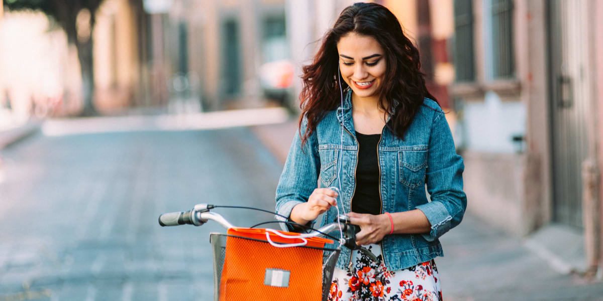 Resident looking at her smartphone while taking a break from her bike ride near Carvel Harbour Pointe in Mukilteo, Washington