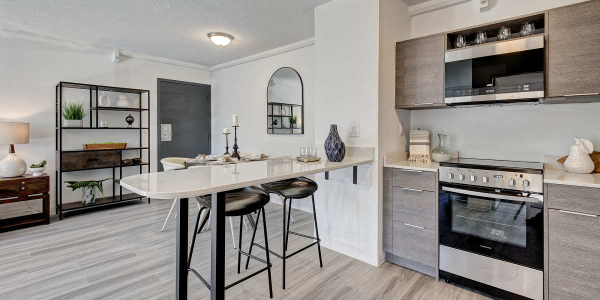 Open kitchen with wood flooring at The Otis in Dallas, Texas