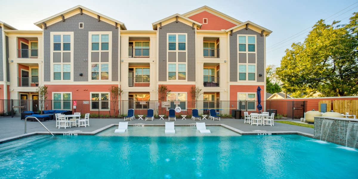 Apartment building exterior with pool at Magnolia Park Apartments in Houston, Texas 