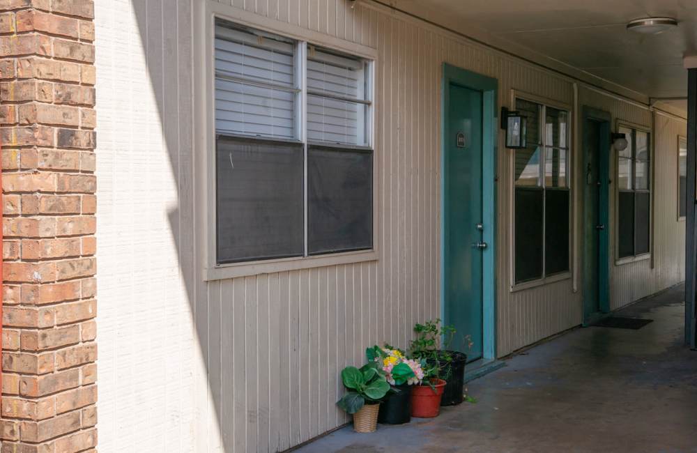 A close-up view of the exterior of a motel or apartment building at Sierra Ridge in Austin. TX