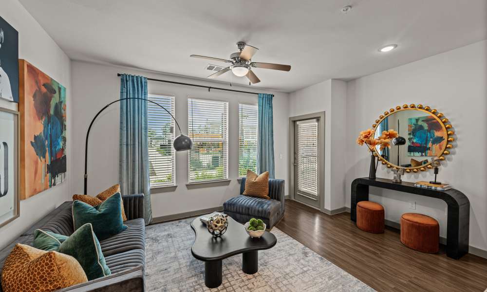 Living room with ceiling fan at Opal Point at Kyle in Kyle. TX