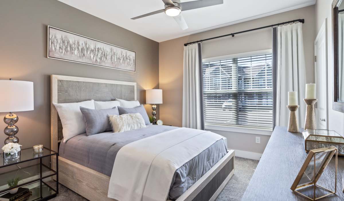 Modern bedroom with cozy furnishings and natural light at Gentry East Apartments in Cincinnati, Ohio