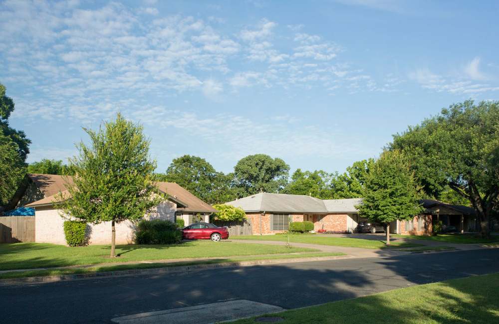 Property exterior with a parking area at Cherry Creek Duplexes in Austin, Texas