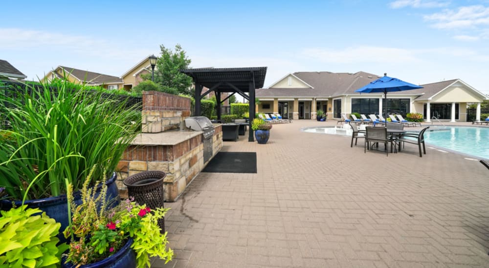 Pool side and in the pool seating available at Grand Villas Apartments in Katy, Texas