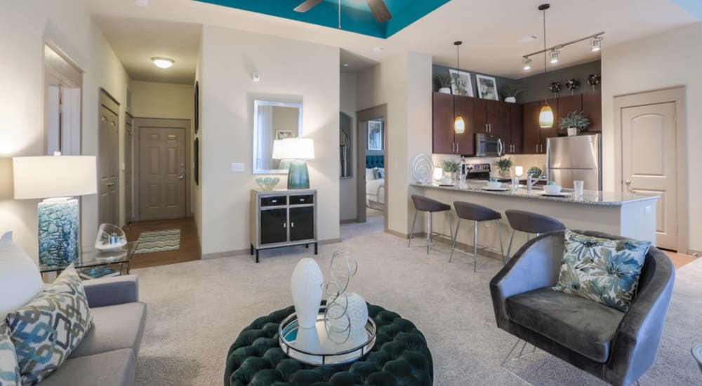 Spacious living room and gourmet kitchen of a model apartment home at Imperial Lofts in Sugar Land, Texas