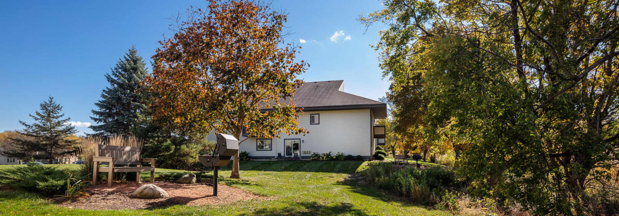 Barbeque area with seating at Pine Cove Apartments in Oregon, Wisconsin