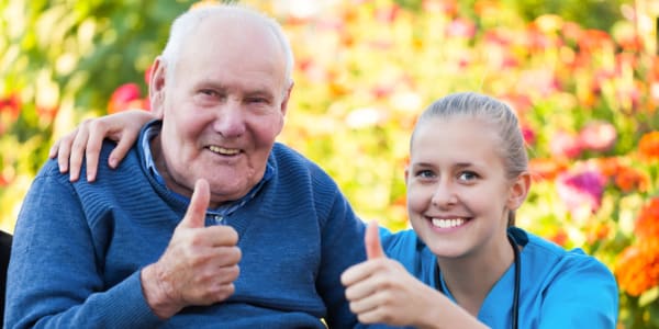 Resident and nurse giving a thumbs up at Edgerton Care Center in Edgerton, Wisconsin