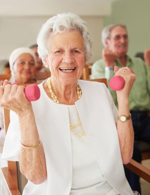 Woman exercising with weights at The Phoenix at Lady's Island in Beaufort, South Carolina
