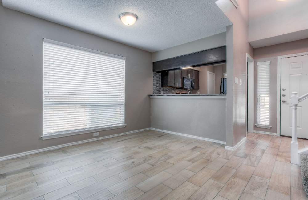 Modern apartment with view of kitchen and stairs to the next level at The Quorum At Trophy Club in Trophy Club, Texas