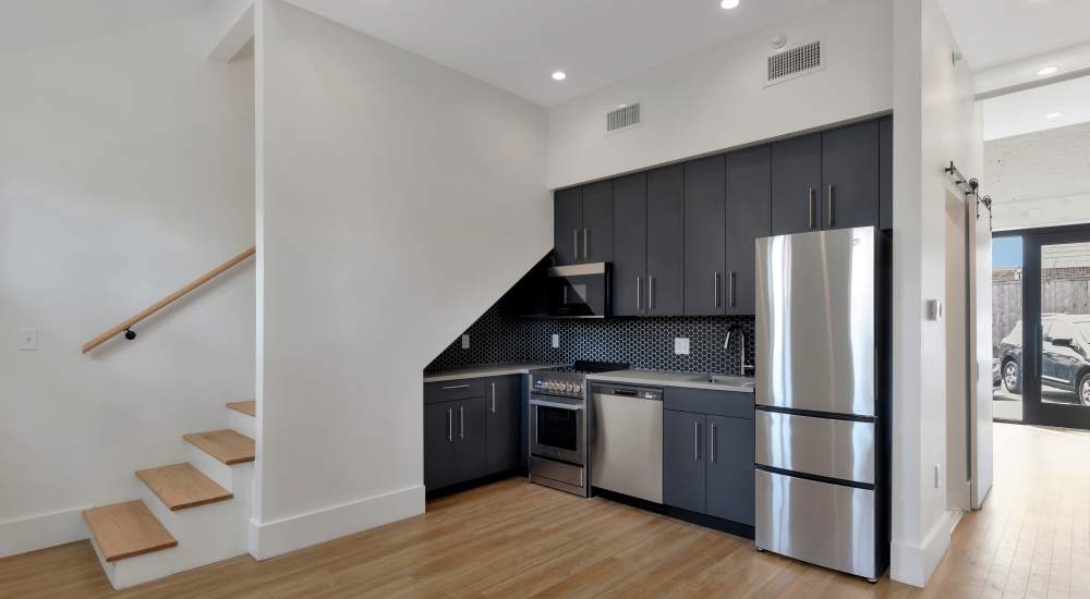 Spacious kitchen with steel appliances near stairs at 189 Barksdale in Memphis, Tennessee
