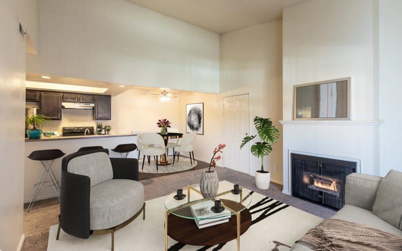 Living room with a fireplace and high ceilings at Shadowbrook Apartments in West Valley City, Utah