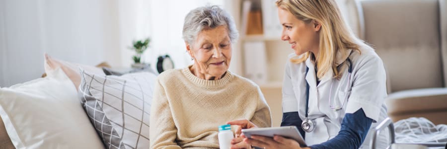 Resident managing their medications with their caretaker at Edgerton Care Center in Edgerton, Wisconsin