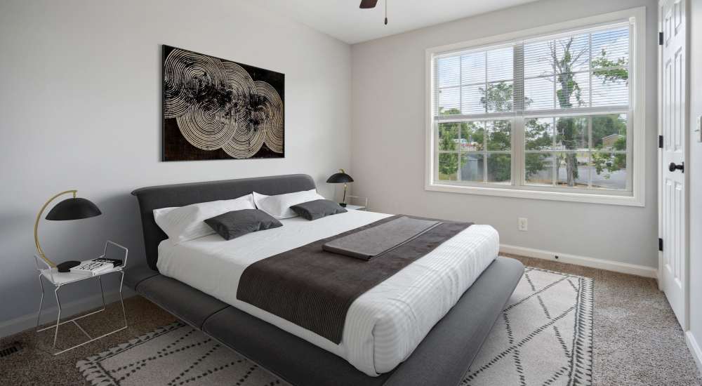 Cozy bedroom with a large comfortable bed at Northpark Commons in Clarksville, Tennessee.