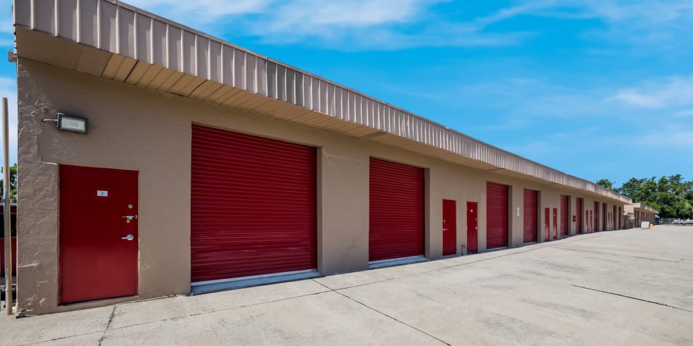 Outdoor storage units with red doors at StorQuest Self Storage in Sarasota, Florida