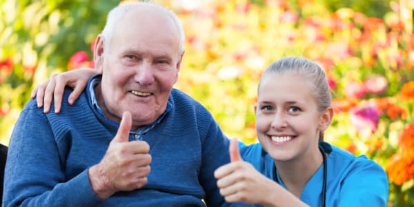 Resident and nurse giving a thumbs up at Geneva Lake Manor in Lake Geneva, Wisconsin