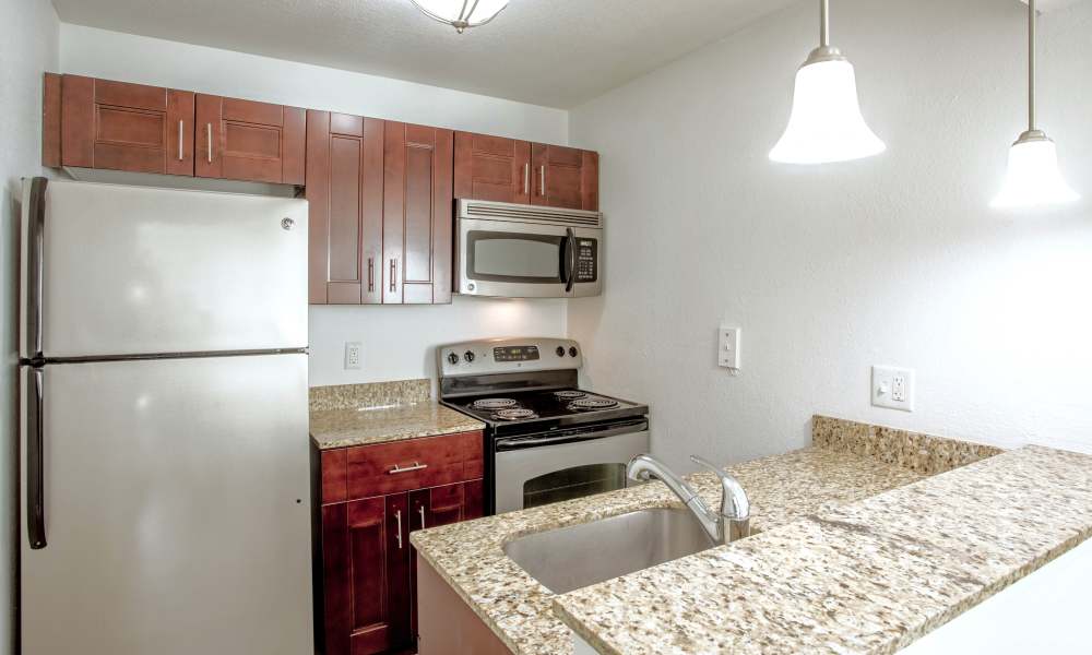 Modern kitchen with stainless steel appliances at Visions at Willow Pond in West Palm Beach, Florida 
