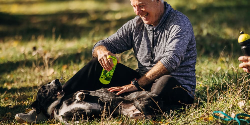 Resident playing with his dog at Olea Beach Haven in Jacksonville, Florida