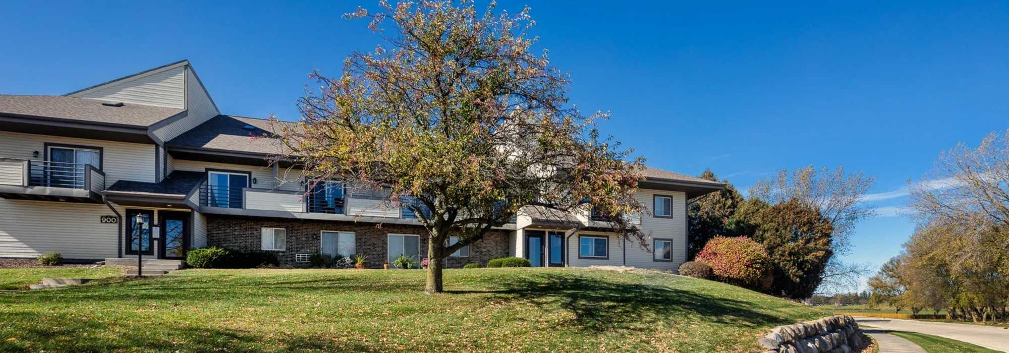 Community apartment with green lawn at Pine Cove Apartments in Oregon, Wisconsin