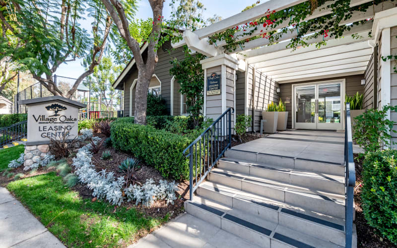The sign and stairs to the leasing office at Village Oaks in Chino Hills, California