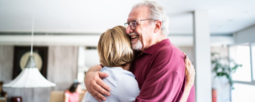 A man and woman embracing at a Ridgeline Management Company senior living property