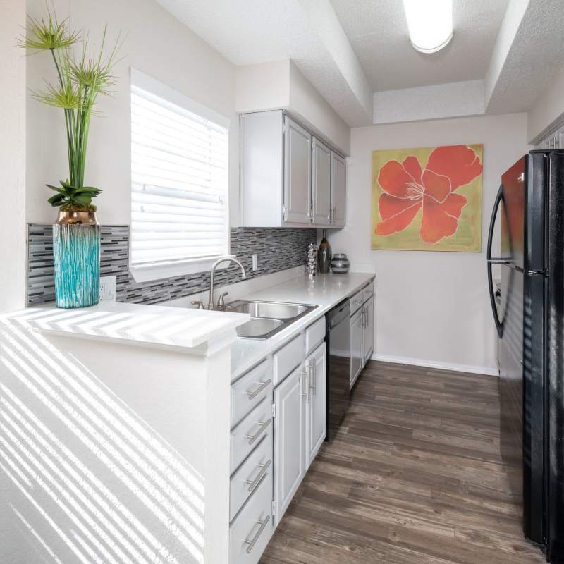 Well-equipped kitchen with granite countertops of apartment at Copper Chase in Arlington, Texas