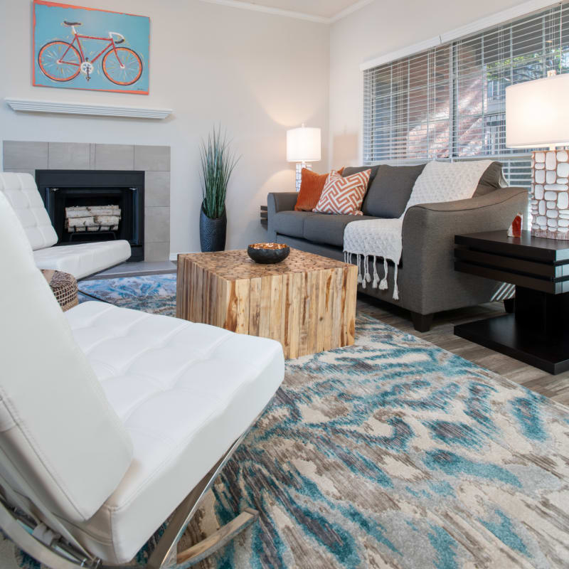 Model apartment living area with fireplace at Copper Chase in Arlington, Texas