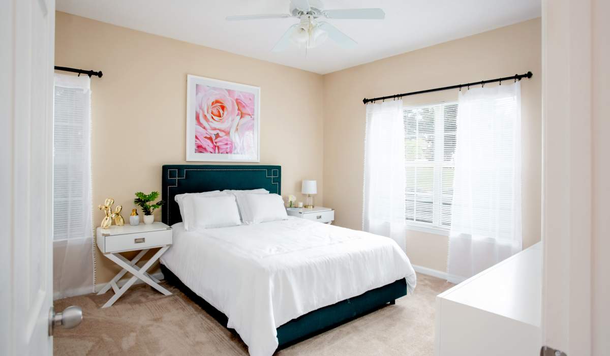 Comfortable bedroom with carpet flooring at Madison Park in Madison, Alabama