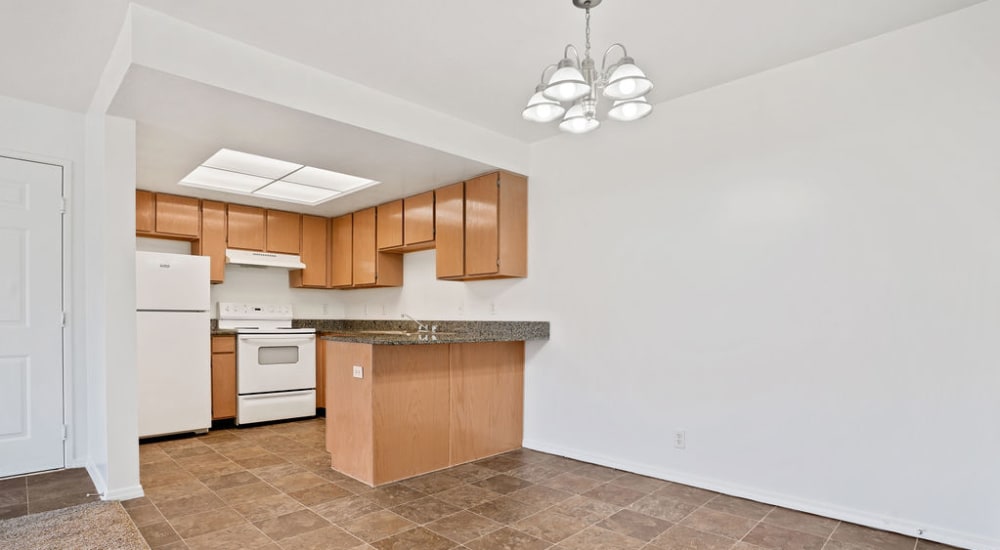 An apartment kitchen and dining room at Clinton Towne Center Apartments in Clinton, Utah