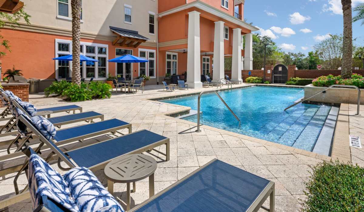 Inground pool with lounge chairs at Station House at Lake Mary in Lake Mary, Florida