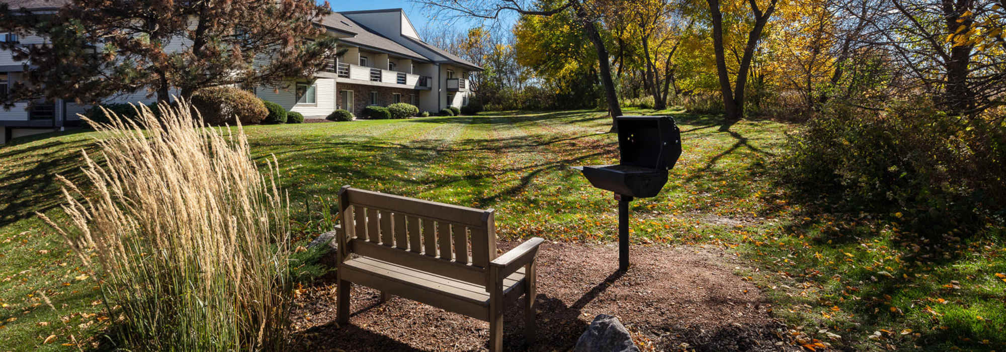 Grilling Stand with Bench for Picnic Area at Pine Cove Apartments in Oregon, Wisconsin