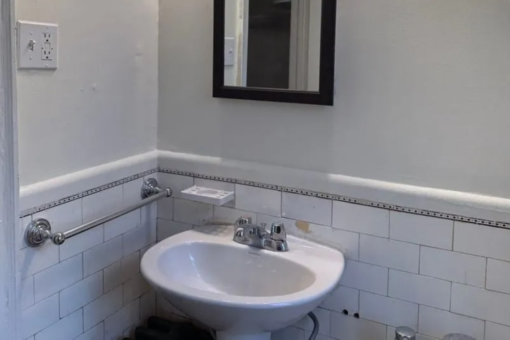 Bathroom with a mirror and a sink at Detroit Living in Detroit,Michigan