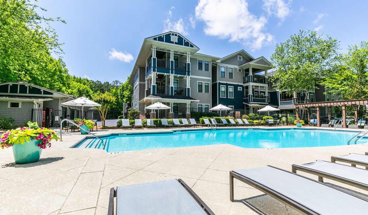Swimming pool with loungers at The Reserve at Johns Creek Walk in Johns Creek, Georgia