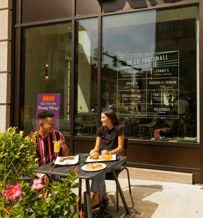 A couple enjoying a meal at a cafe near Reside MKT in Wilmington, Delaware