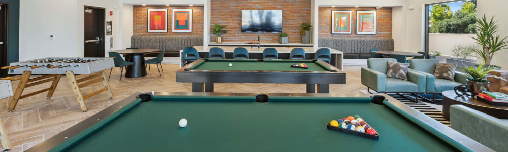 Community lounge with a game room at Lincoln Landing in Hayward, California