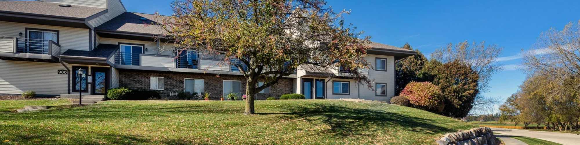 Beautiful exterior of the community with greea area atPhoto Gallery | Pine Cove Apartments in Oregon, Wisconsin