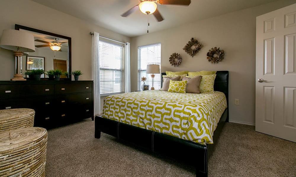 Bedroom with plush carpeting at Tuscana Bay Apartments in Corpus Christi, Texas