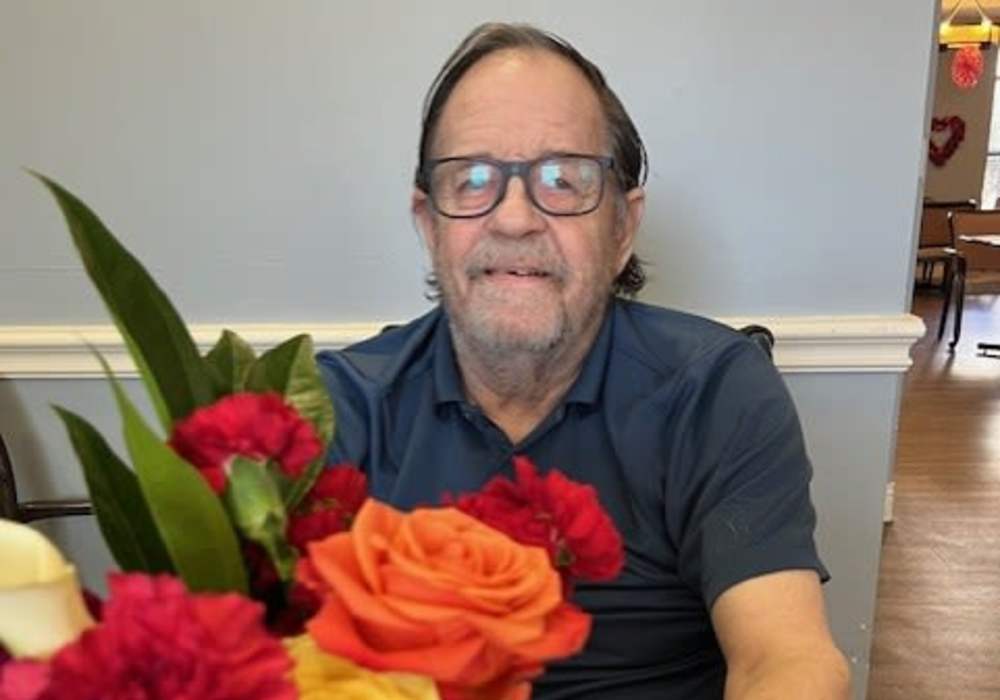 Resident with a flower arrangement at Truewood by Merrill, Keller in Keller, Texas