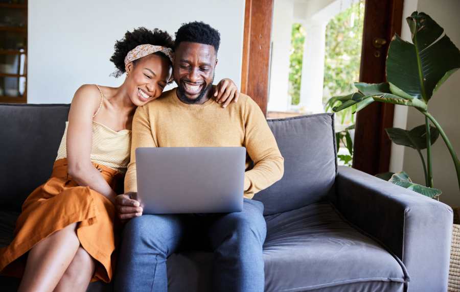 Couple enjoying time together on couch at Balcones Trails in Kyle, Texas