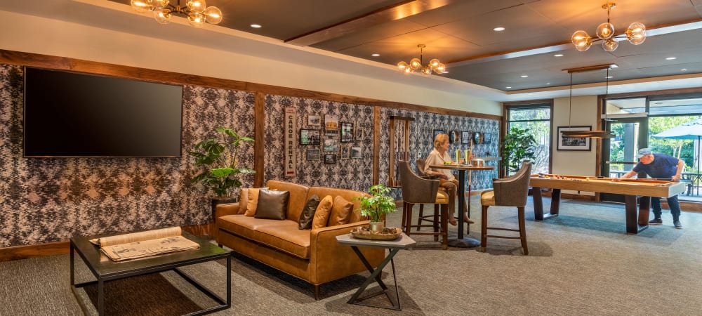 Activity lounge with games, a bar, and tv's at The Springs at Lake Oswego in Lake Oswego, Oregon