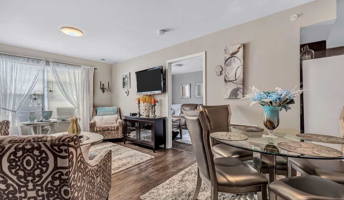 Well-lit living room with air conditioning at Audubon Crossing Senior Community in Dayton, Ohio