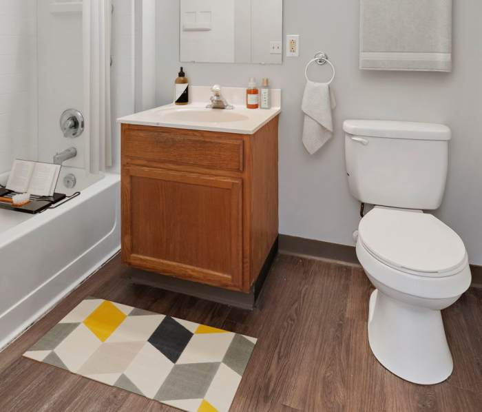 Bathroom with a large mirror at Wilson School Apartments in Muncie, Indiana