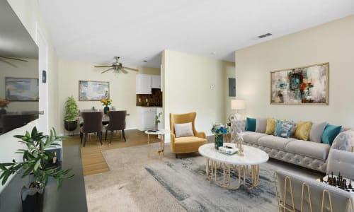 A dining room table and furnished living room at The Residence at Patriot Place in Columbus, Georgia