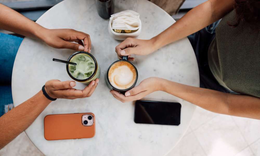 Residents with coffee mugs sitting near table at Global Ruston in Ruston, Louisiana