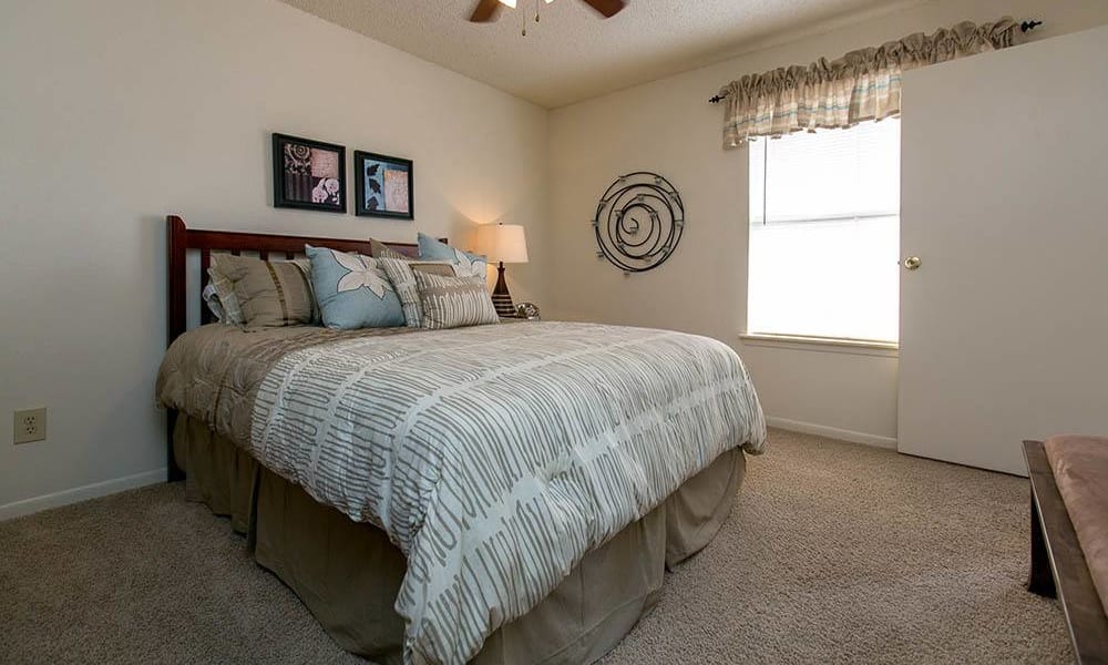 Bedroom with a ceiling fan at Walnut Ridge Apartments in Corpus Christi, Texas